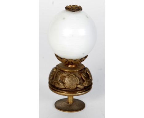 A Chinese gilt metal and white glass hat finial, circa 1900, floral decorated mounts, height 7.5cm.   Condition report:  Thre