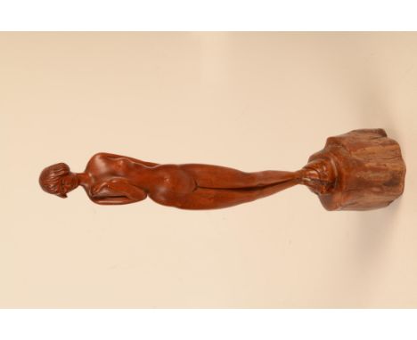 A carved fruitwood figure of a lady standing on a tree trunk, height 53cm.