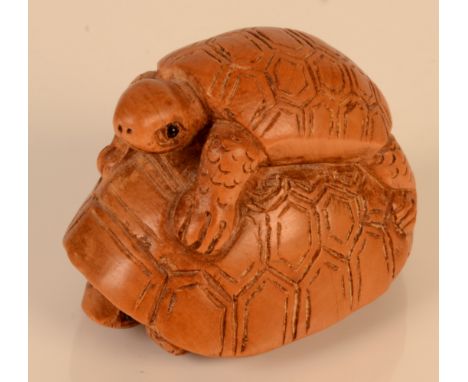 A wooden netsuke carved as two turtles, height 3cm, length 4.5cm. 