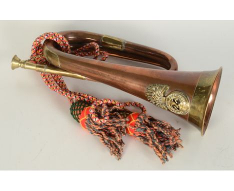 A 24th Royal Welsh Fusiliers brass and copper bugle, with tasselled cord, length 31cm.   Condition report:  