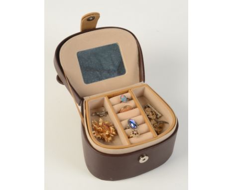 An opal ring and other jewellery in a leather box.