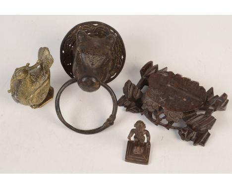 A Chinese carved hardwood stand, height 4cm, width 14.5cm, depth 9cm, a bronze door knocker and two figures.