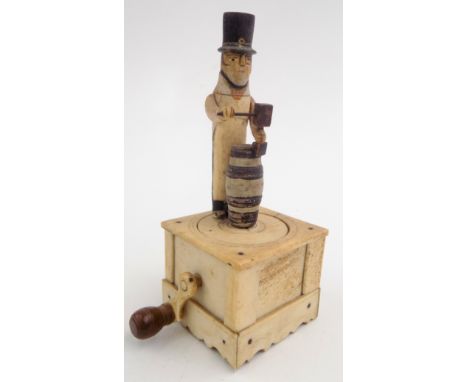 A Napoleonic French prisoner of war carved bone automaton of a cooper, standing behind a barrel, the hand crank turning a rev