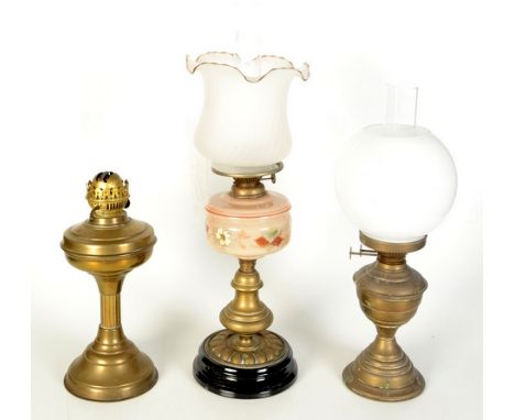 A Victorian brass oil lamp, with opaline glass shade, full height 62cm and two other brass oil lamps, full heights 49cm and 5
