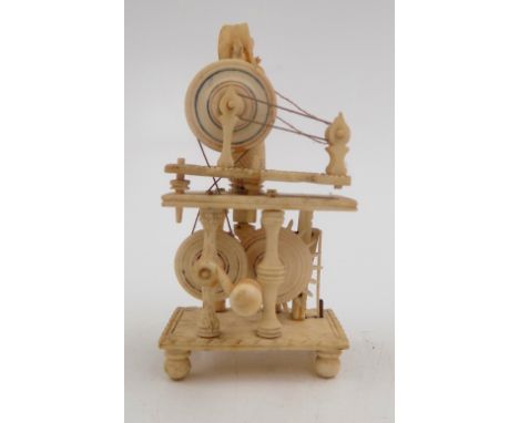 A Napoleonic French prisoner of war carved bone spinning Jenny automaton, early 19th century, the figure standing behind a wh