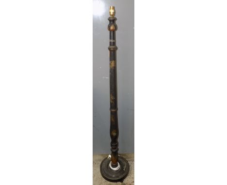A black japanned standard lamp, the turned column with gilt floral sprays and an exotic bird, the circular platform base with