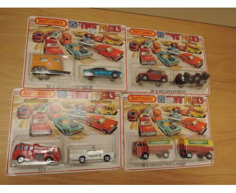 Four 1975 Matchbox 75 Two Packs, TP1 Mercedes Truck &amp; Trailer, TP2 Police Car and Fire Engine, TP3 Javelin &amp; Pony Tra