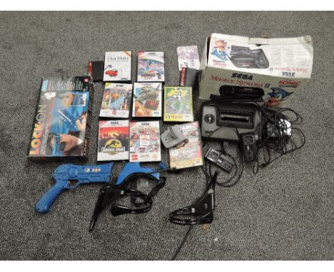 A Sega Master System II Console with two Controllers and Instructions in original box along with seven Sega Master System Car
