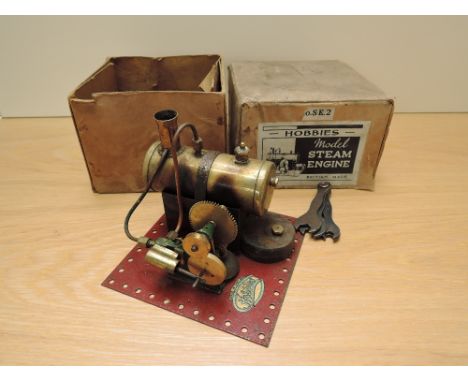 A Hobbies No SE2 Live Steam stationary Single Cylinder Engine having copper boiler and burner present, on Meccano style base,