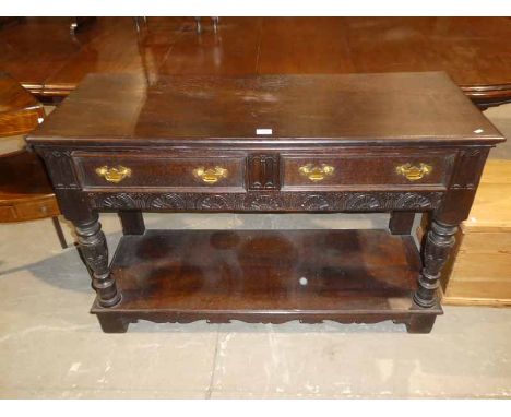 Early 20th century Jacobean revival oak sideboard/buffet with pot shelf base.