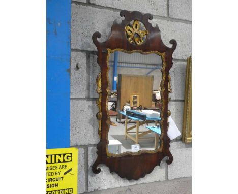 An 18th century mahogany Chippendale style wall mirror, with pierced cartouche and gilt fruit and foliage to the flanks, 84 c