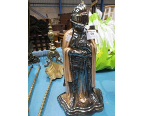 A cast iron and enamel Knight fireside companion set.