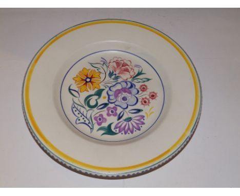 A Poole painted plate decorated flowers..