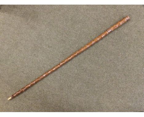 A wooden swordstick with copper banding & endpiece.