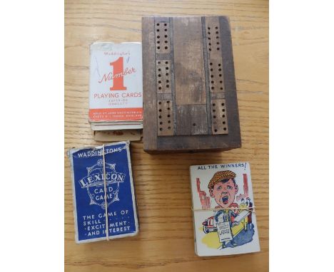 A folding cribbage board, Snap and two other packs.