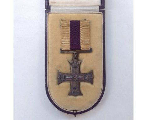 A WWI Military Cross awarded to Lt. J.P. McKenzie RE, accompanied by two newspaper cuttings explaining that he was awarded th