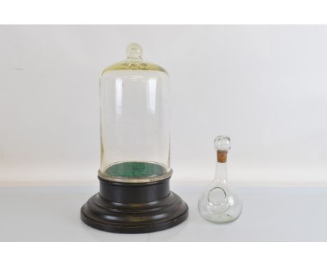 A 19th Century Victorian glass dome, set on ebonised base. 55cm tall. Together with a Victorian glass laboratory flask with c