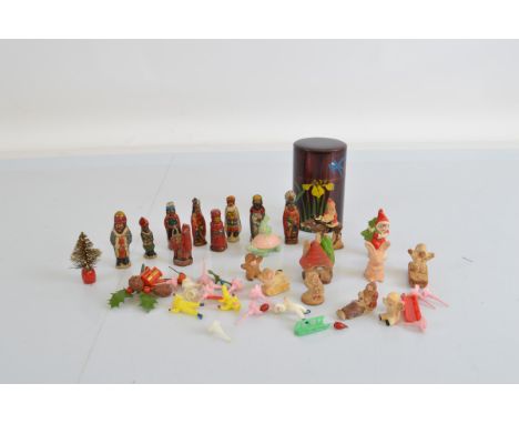 A quantity of bisque Snow Babies, including Santa Claus on a Reindeer, sledding children, etc. Together with a cannister of v