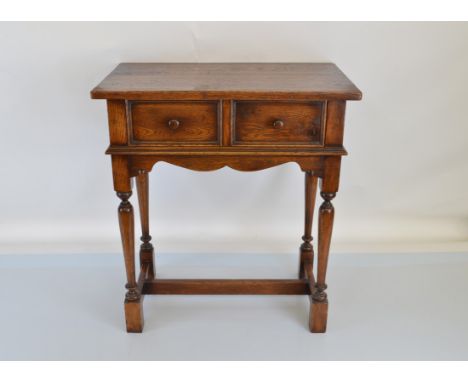 A 1900s oak side table, having fielded panelled drawer, shaped apron, turned leg, block feet. 64cm x 38 x 772 high.