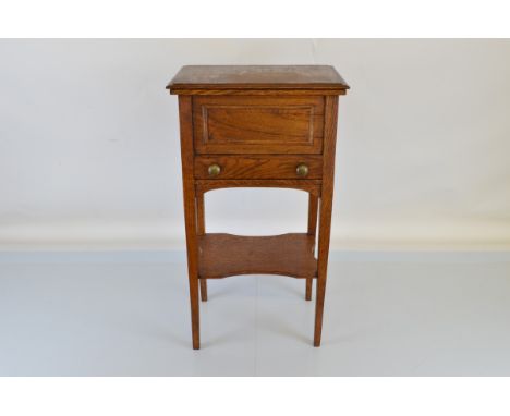 An oak sewing table, with rectangular top section, with lift top and two fitted removable trays with void underneath. Having 