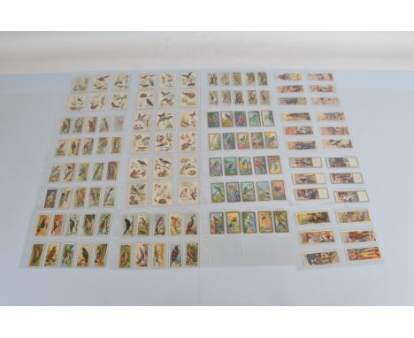 An album containing assorted cigarette and tea card sets, containing Players, Ogdens, Cavanders, Typhoo, Carreras, Wills, Sen