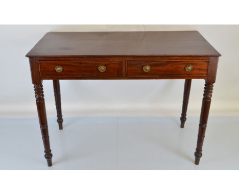 A Victorian mahogany side table, having two drawers with brass ring handles, turned supports. 101cm x 49.5cm x 75cm tall.