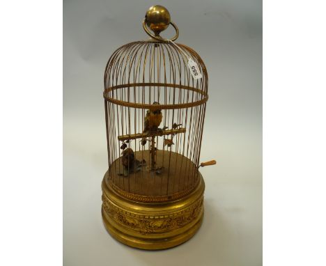 SINGING BIRD AUTOMATON, two feathered birds, one on a perch, in a gilt metal cage, base stamped 'Made in France', height 51cm