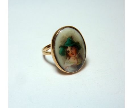 A ROSE GOLD PORTRAIT RING, panel depicting a young boy to a plain surround and tapered band, stamped 9ct, ring size H