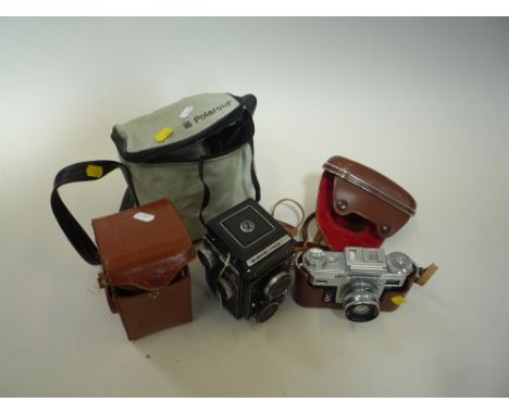 A YASHICA LM TLR CAMERA, with leather case, a Kiev SLR in case and a cased Polaroid The Button (3)