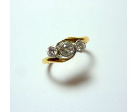 A DIAMOND RING, with three old cut diamonds on a twisted band, estimated total diamond weight 0.50cts, H-I colour, SI1-SI2 cl