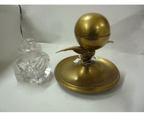 A VICTORIAN BRASS INKWELL, the globe well supported by an Eagle on a circular tray, together with George III cut glass inkwel