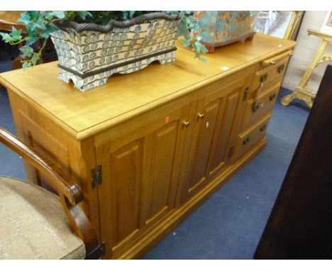 A MODERN LIGHT OAK SIDEBOARD, with slide, three drawers and twin cupboards