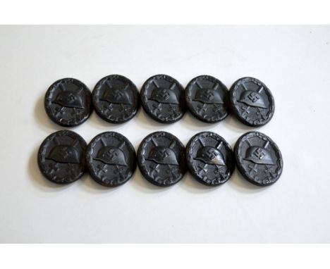 TEN 1ST PATTERN BLACK WOUND BADGE, 1936-1939, Die stamped hollow back M16 style helmet pattern with Swastika stamped on it
