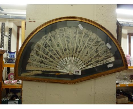 A VINTAGE FAN, with lace work and mother of pearl handle, framed