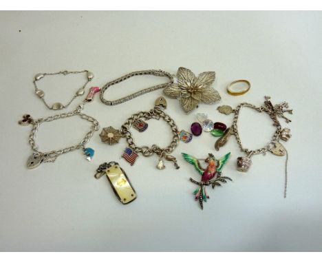 A QUANTITY OF JEWELLERY, to include three silver charm bracelets, a floral shape brooch, a mother of pearl penknife etc