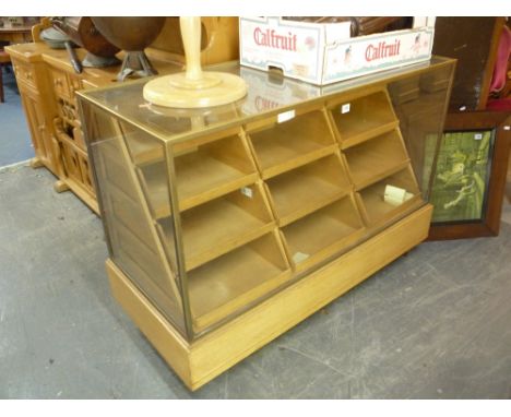 A LIGHT OAK AND BRASS FRAMED GLAZED HABERDASHERY/SHOP DISPLAY COUNTER, with twelve waterfall display drawers