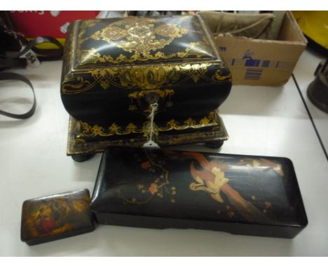 A VICTORIAN LACQUERWORK TEA CADDY, of sarcophagus form and decorated with gilt scrollwork (s.d.) (key), together with papier 