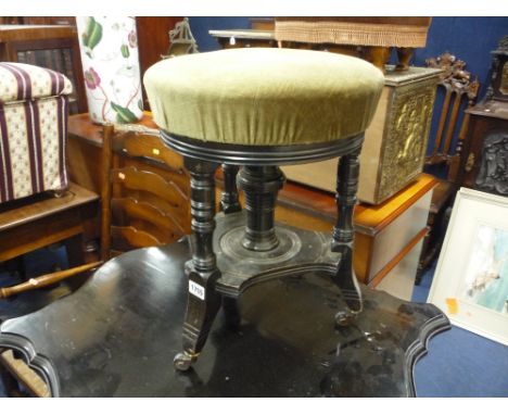 AN EDWARDIAN EBONISED ADJUSTABLE PIANO STOOL