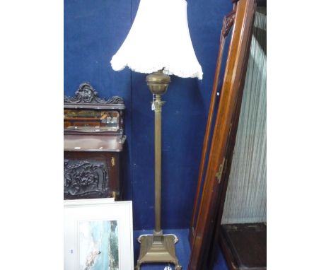 A BRASS OIL LAMP, on corinthium column stand (converted to electricity) with shade