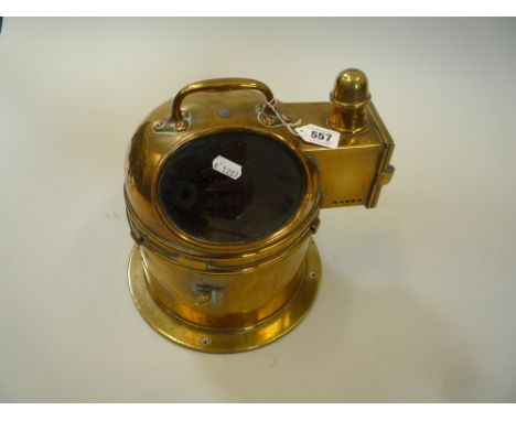 A BRASS CASED MARINE BULKHEAD COMPASS, the domed cover with spirit lamp opening to a gimbal mounted compass dial, height 25cm