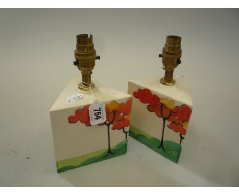A PAIR OF CLARICE CLIFF STYLE TRIANGULAR LAMP BASES, painted with trees, height 14cm (2)