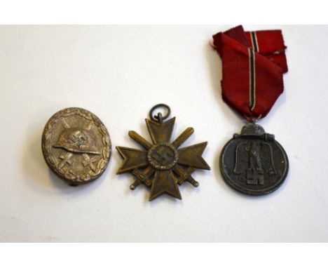 A GROUP OF THREE WWII GERMAN ARMY MEDALS, (Wermacht) 3rd Reich 2nd Class War Merit Cross no ribbon, together with Winterschla