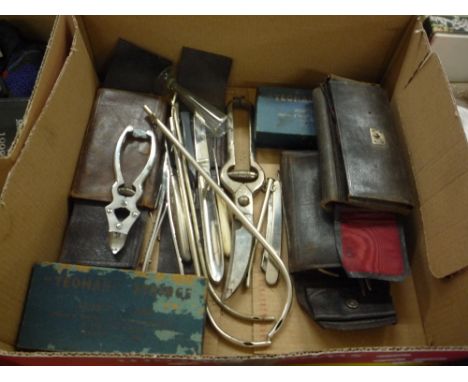 A BOX OF MEDICAL IMPLEMENTS, including two Yeoman Syringes, boxed cutting tools, cathaters etc