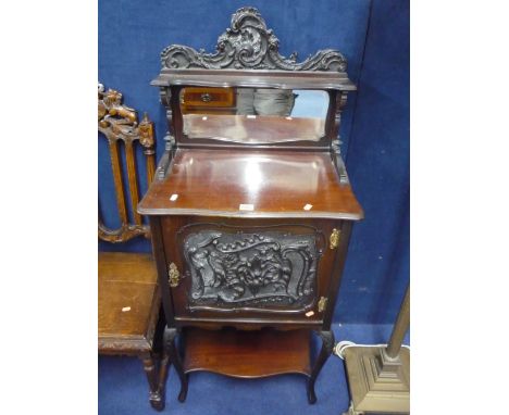 AN EDWARDIAN CARVED MAHOGANY MIRROR BACK MUSIC CABINET, with lower shelf