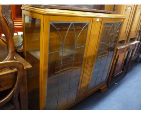 A LIGHT OAK LEAD GLAZED TWO DOOR DISPLAY CABINET, (key) (s.d.)