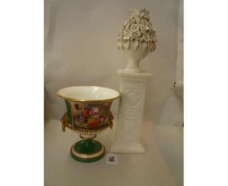 A ROYAL WORCESTER TWO HANDLED FOOTED URN, 1908, shape 2447, signed E. Phillips, puce marks, height 14.5cm (restorations) and 