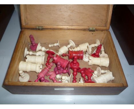 A TURNED BONE PART CHESS SET, natural and red stained, in a inlaid box