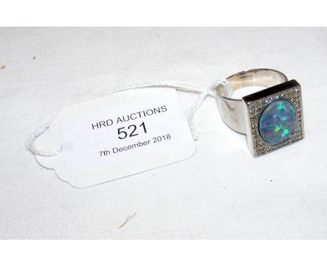 An opal and diamond ring in square 18ct white gold setting 