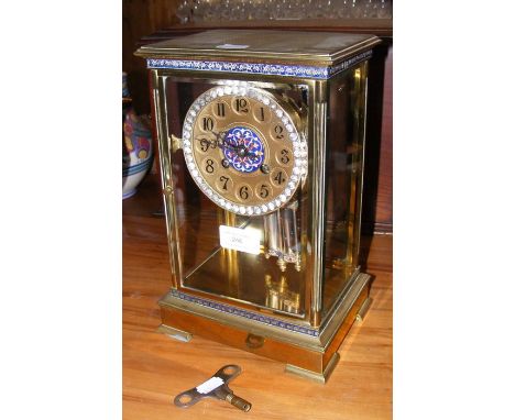 An antique French mantel clock with enamel decoration - 28cm high 