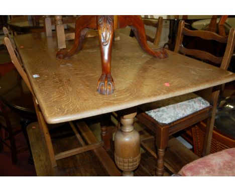 An Ercol mid-elm dining table; together with a set of six Ercol mid-elm dining chairs (3+2) (6) 